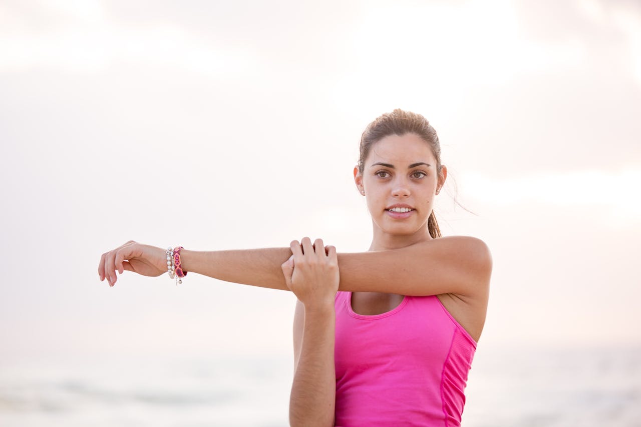 a woman doing a cross-body arm stretch