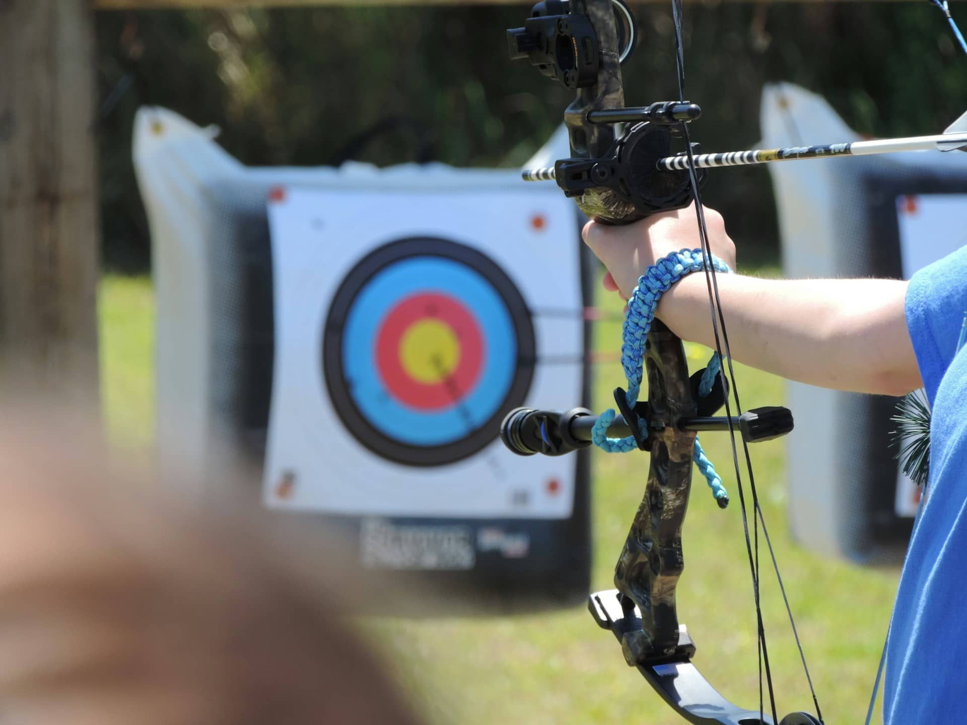 An archer aiming a bow at a target